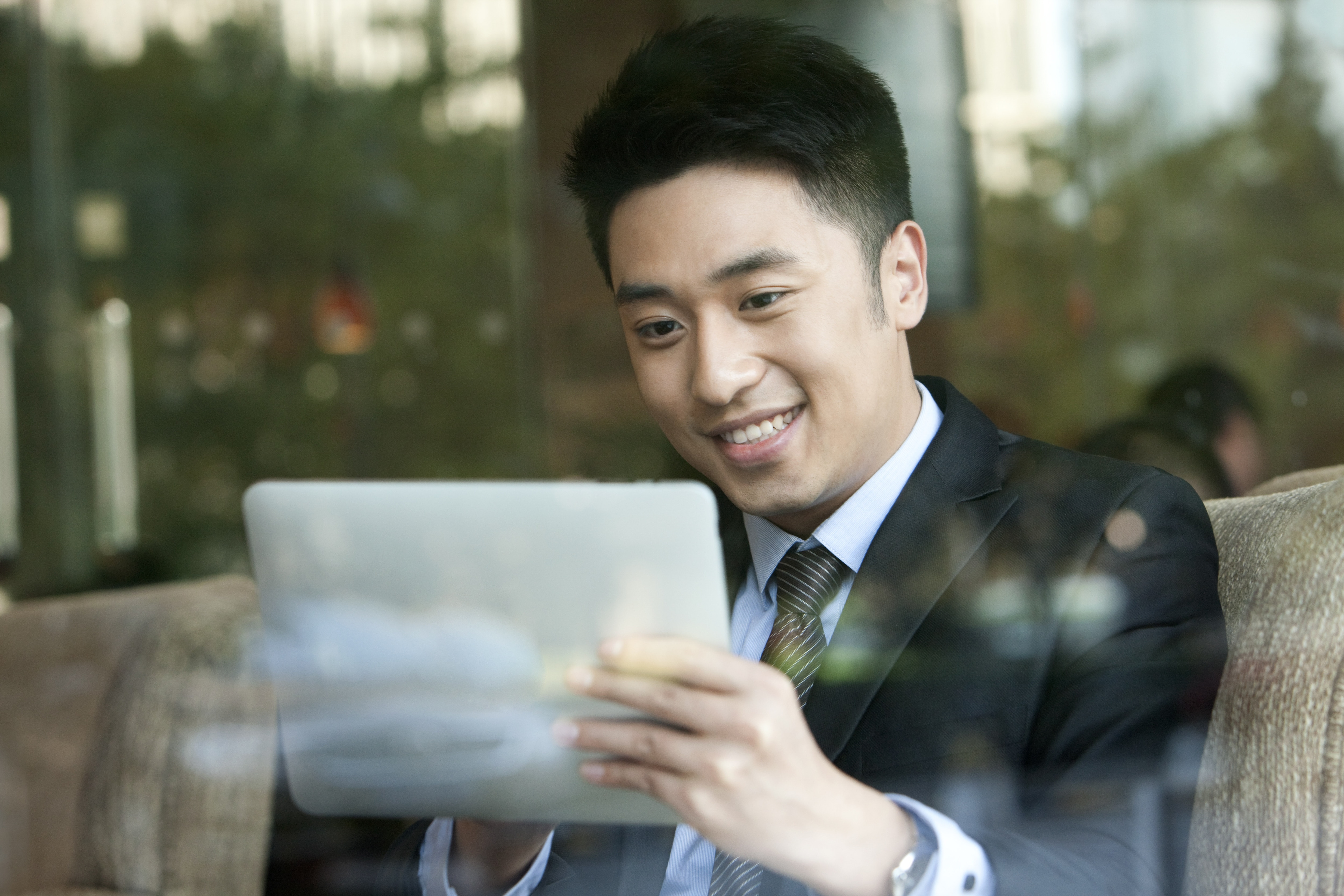 a man looking at his tablet