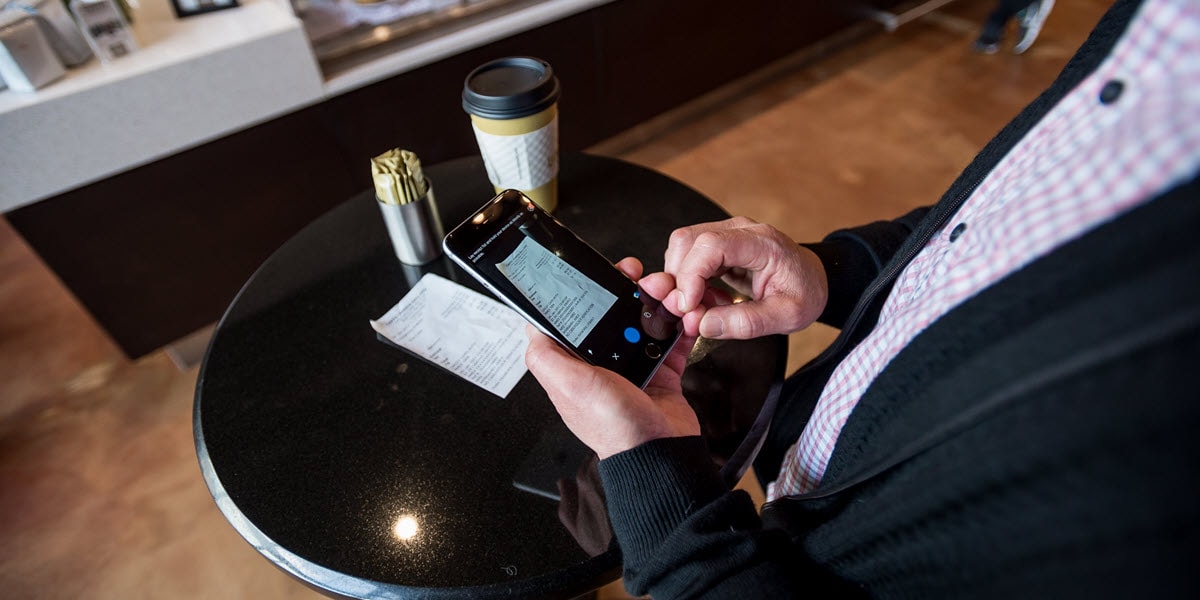 Cafe table with receipt and coffee cup