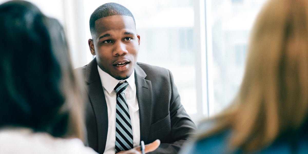 3 person discussion in business setting