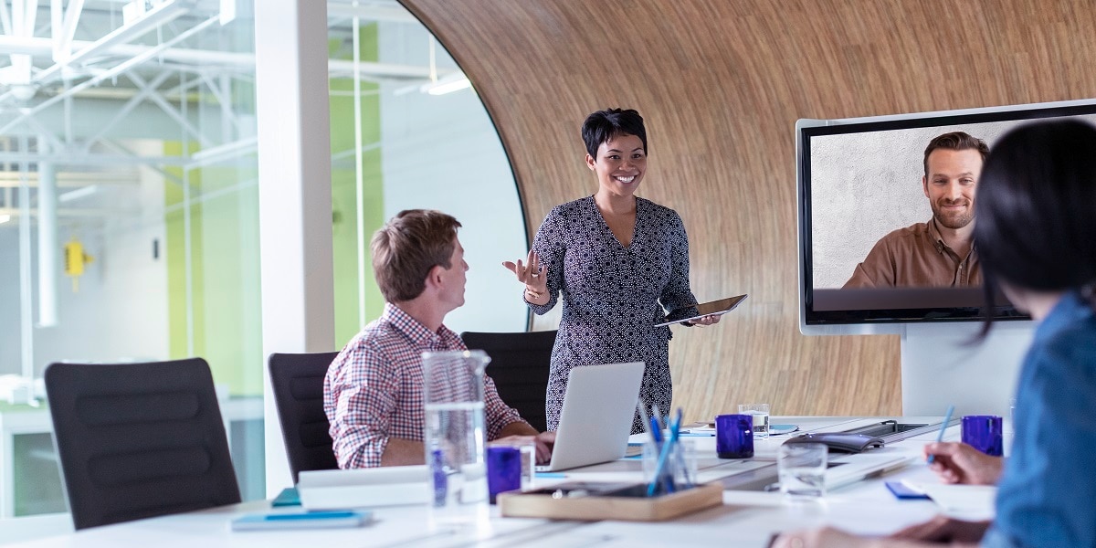 Finance leader in a conference room presenting to a team of people