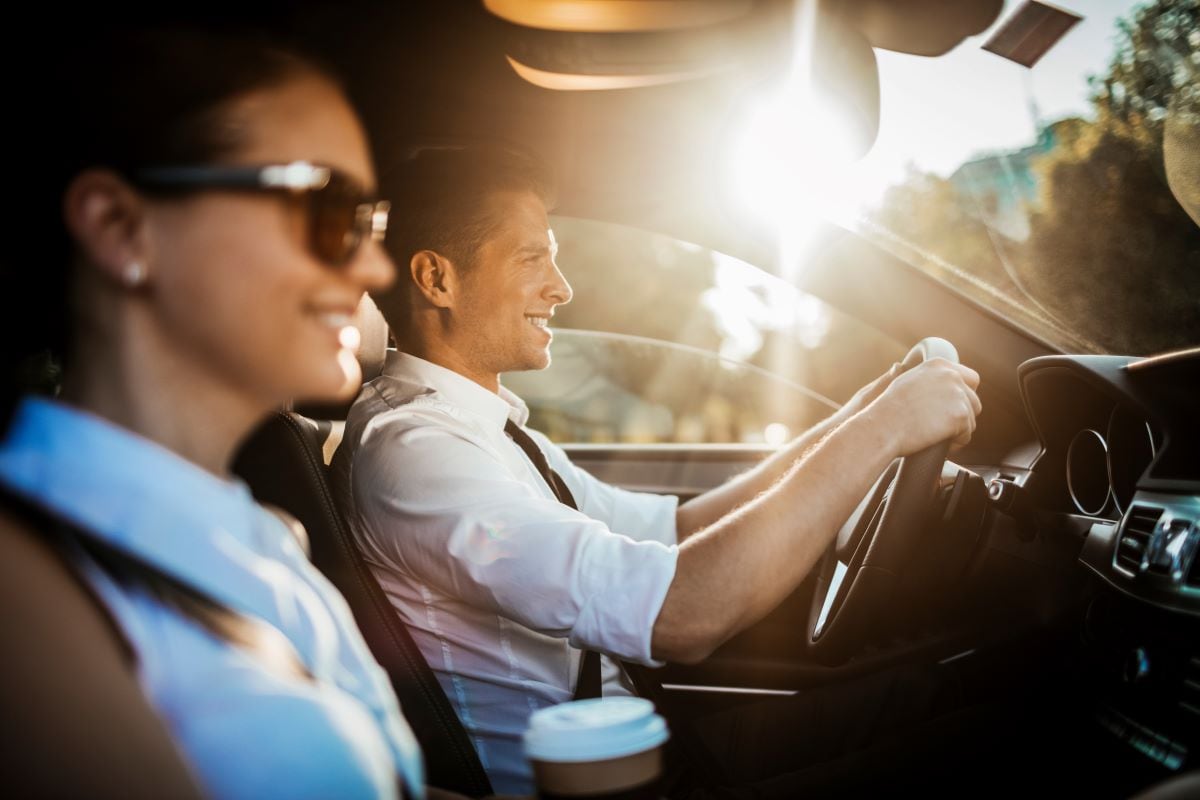 Close-up of two co-workers riding together in a car