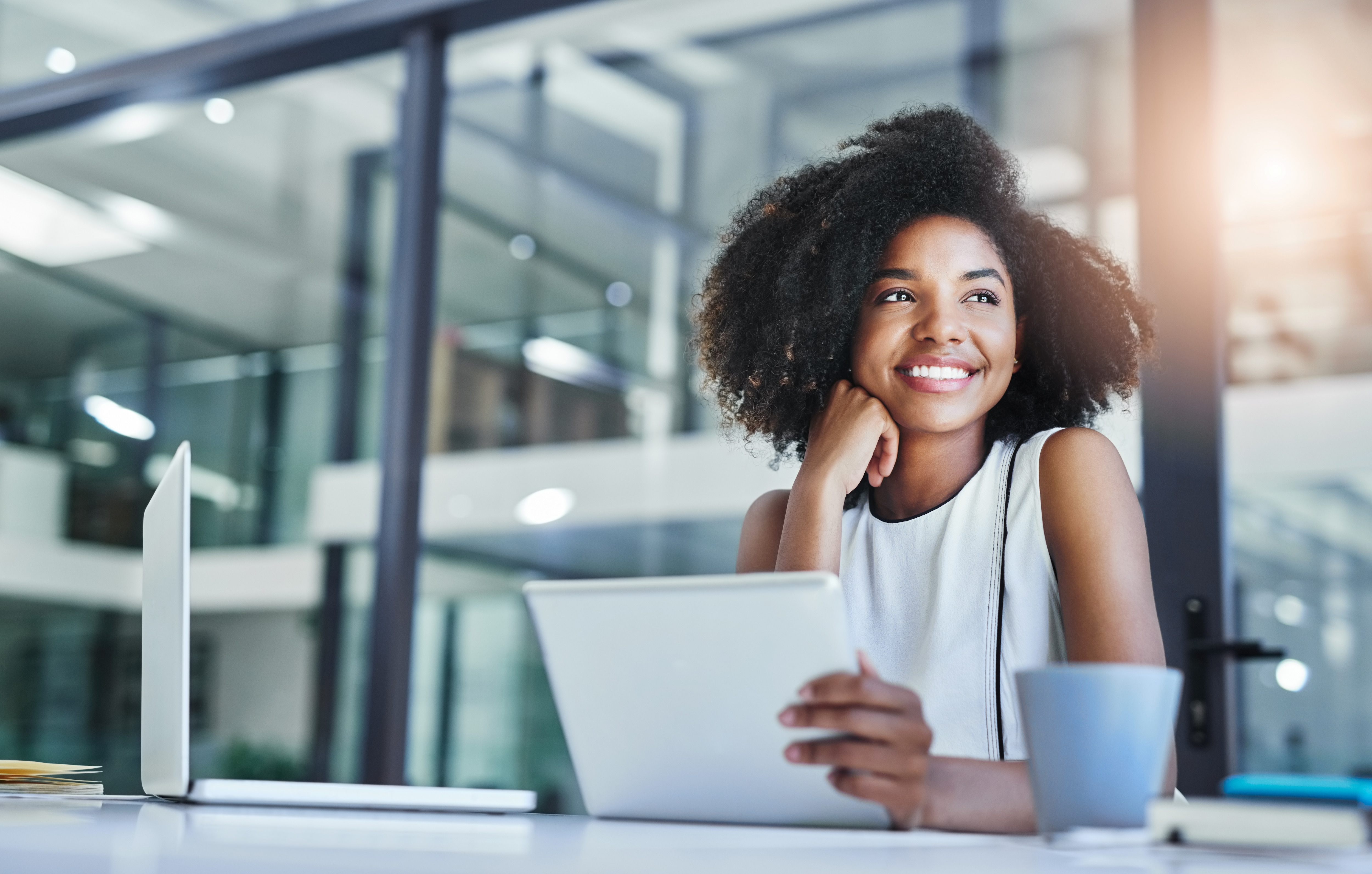 Woman with iPad smiling 