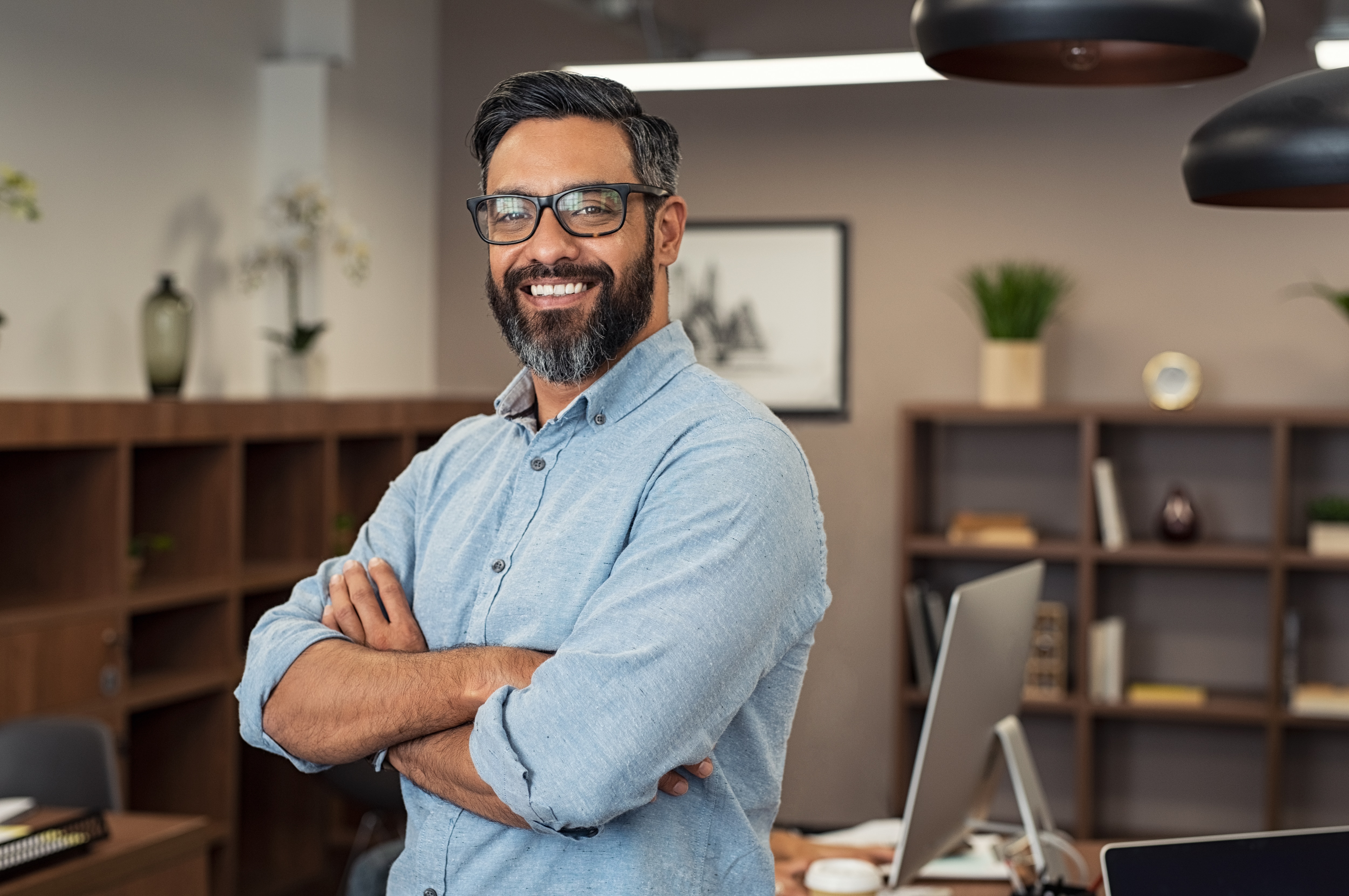 Man smiling looking at camera with arms crossed