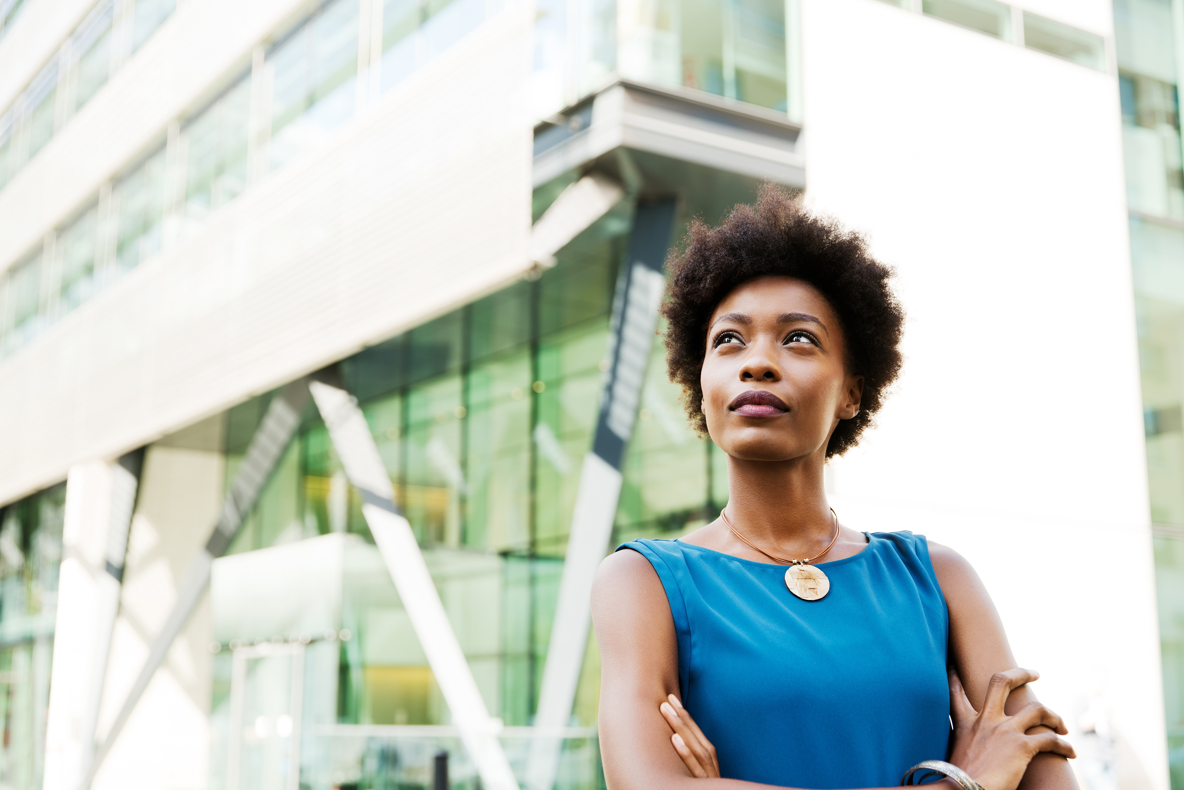 a woman stands in front of a building