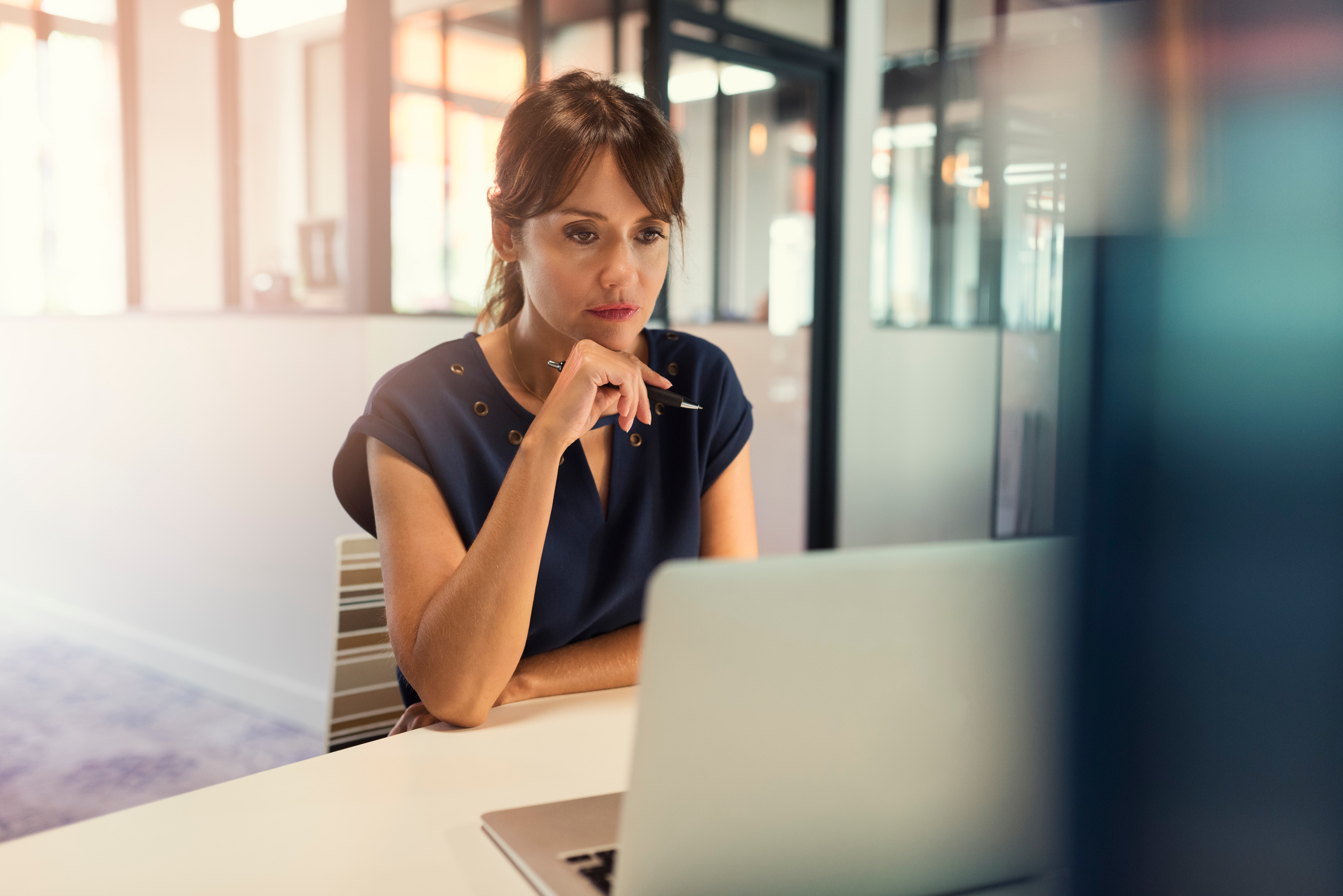 a woman looking at the laptop