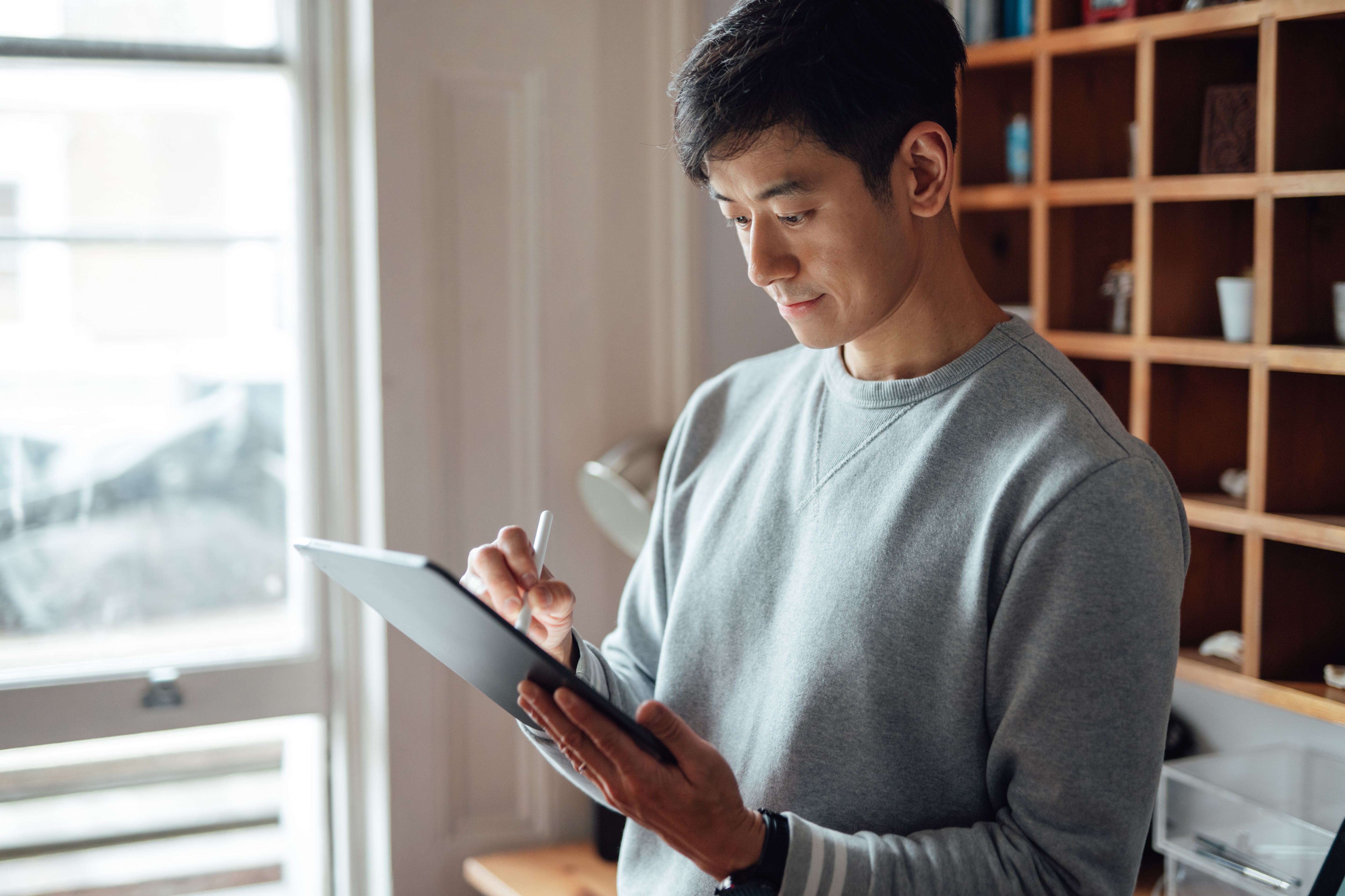 Man looking at ipad in an office