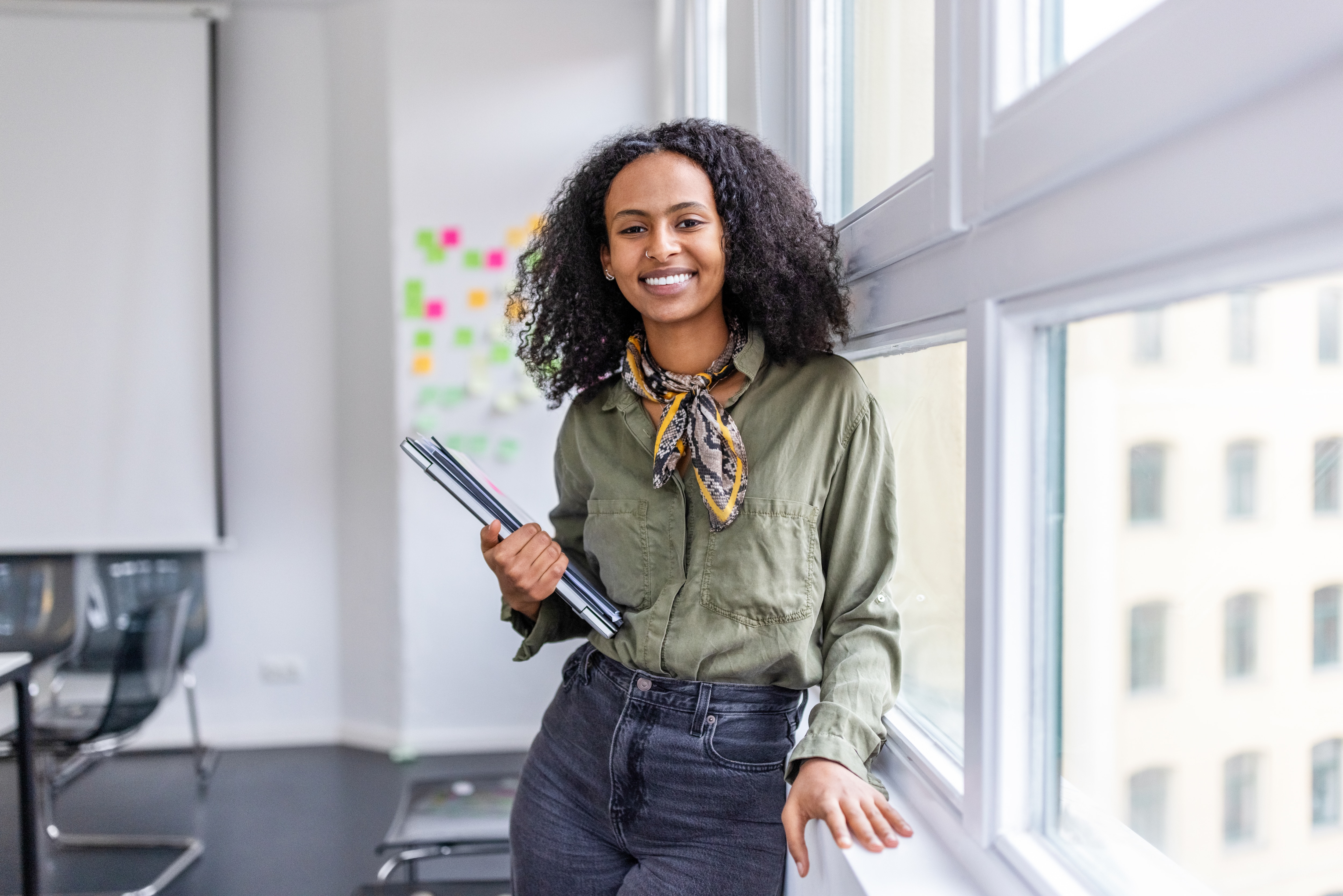 Woman in classroom smiling at camera