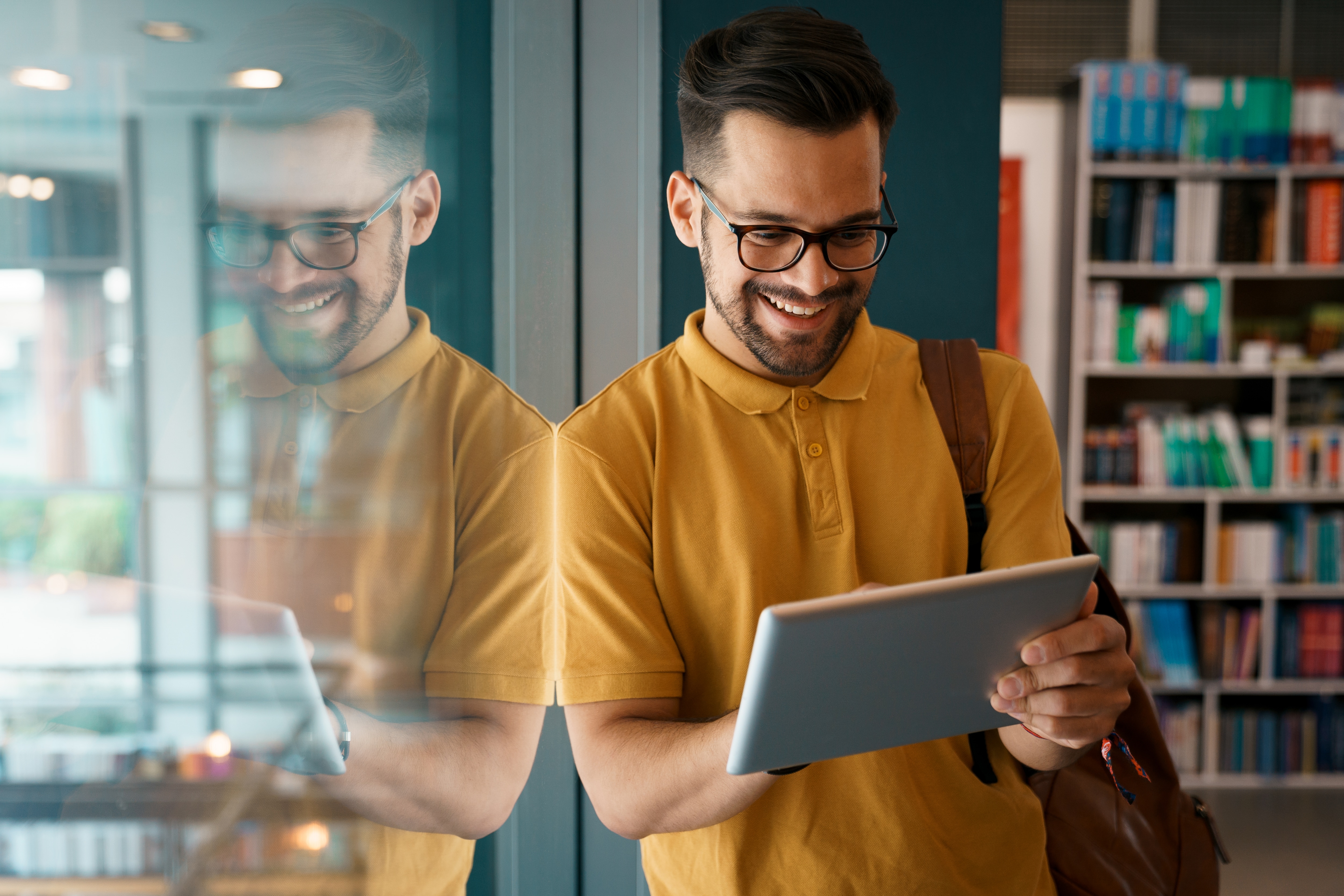 Man smiling looking at tablet