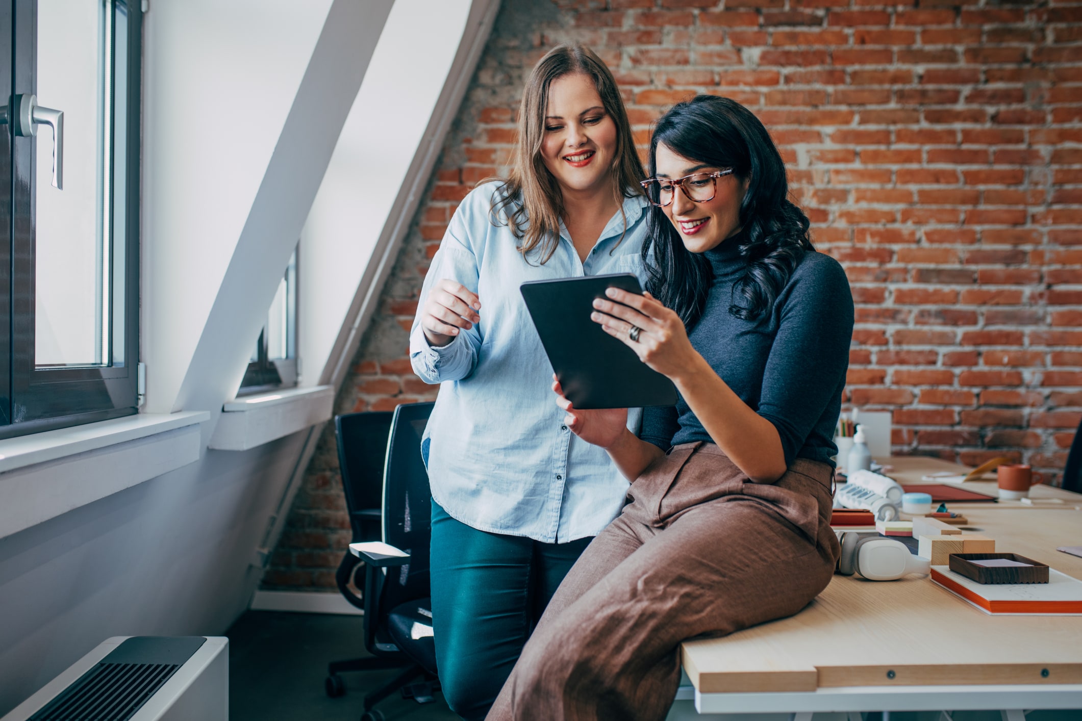 Two businesswomen looking at the ipad