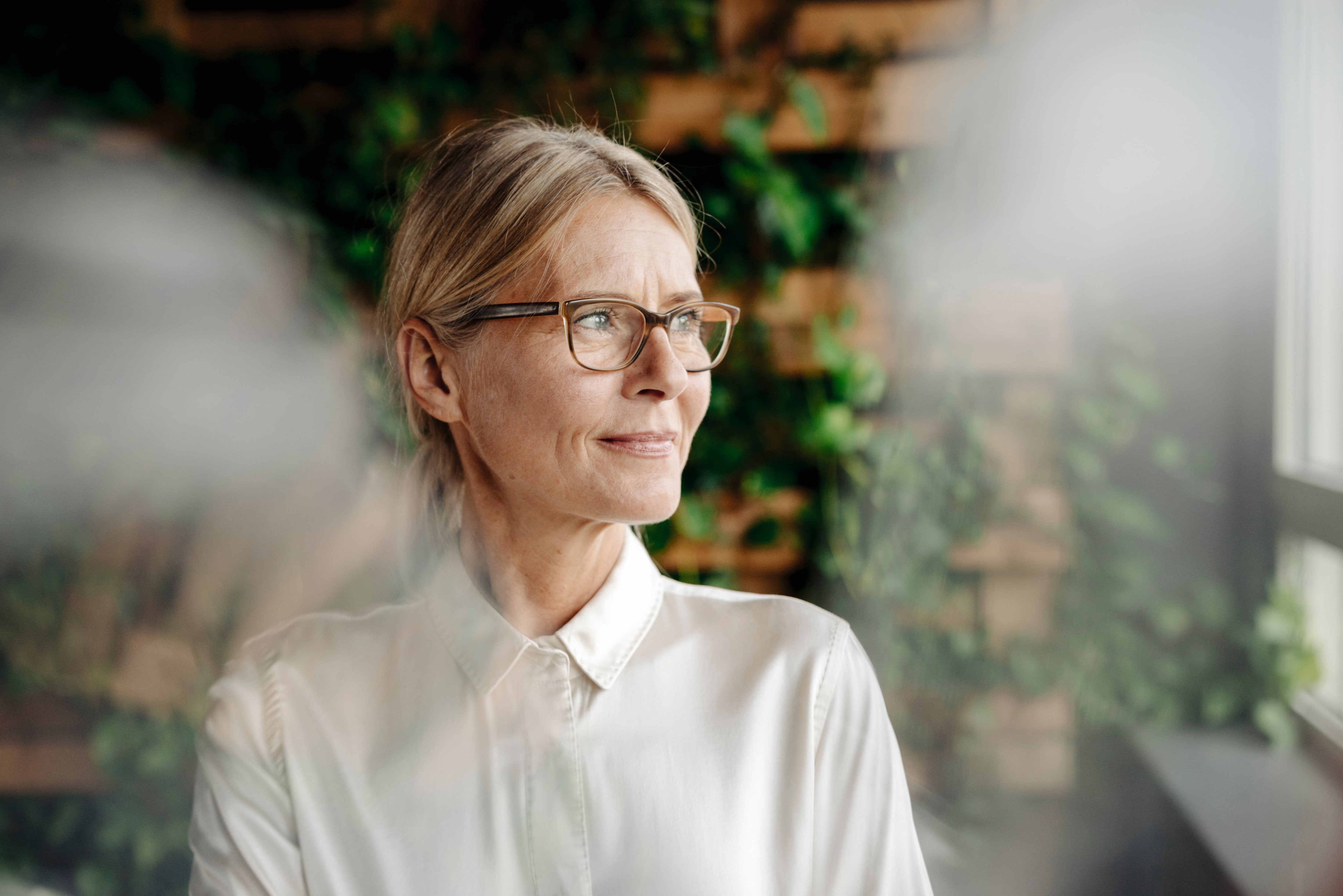 Older woman with glasses looking off to the side