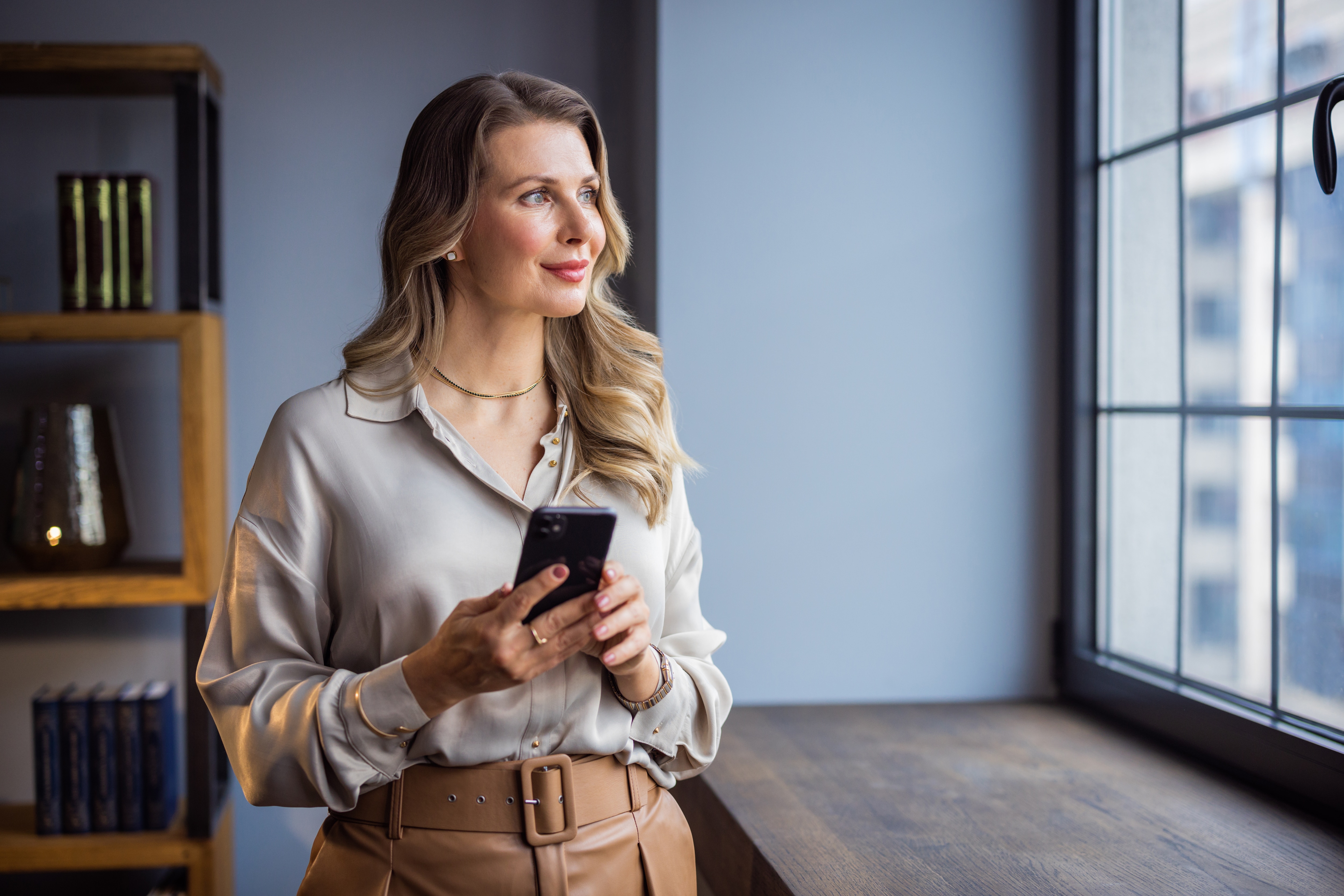 a business woman leader looking outside of the office building