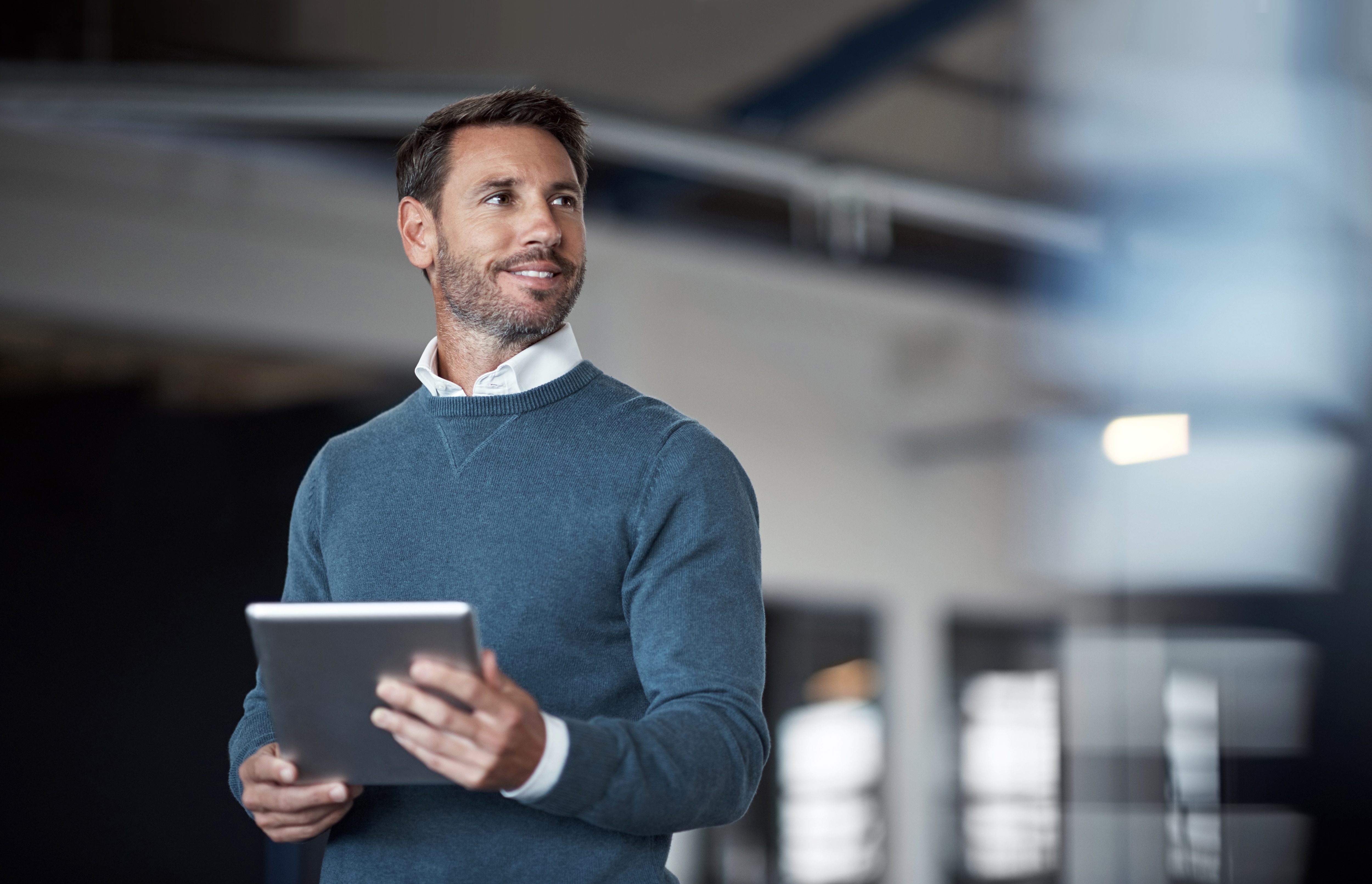 a businessman holding his ipad in the office