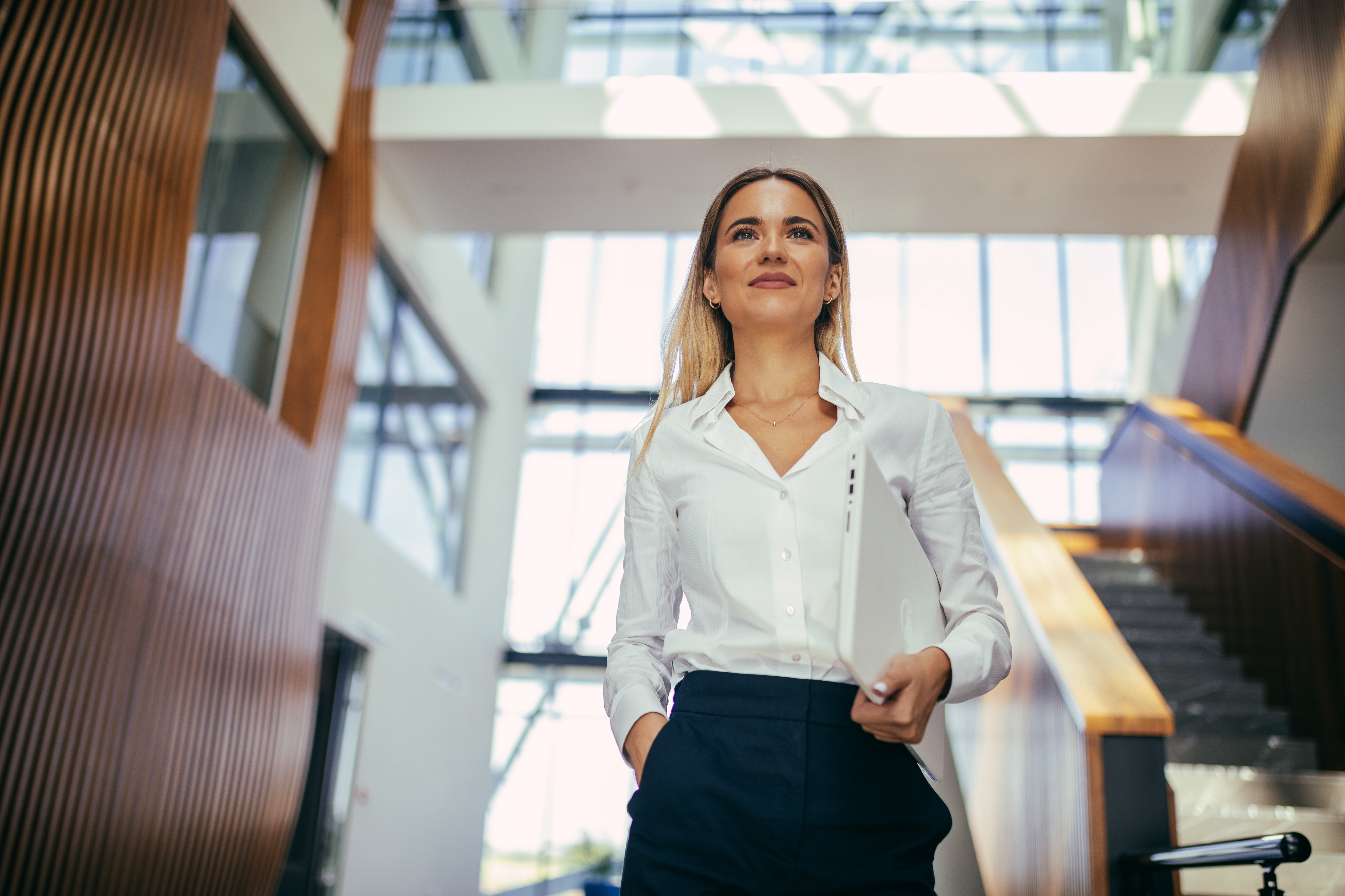 a business woman walking in the hall way