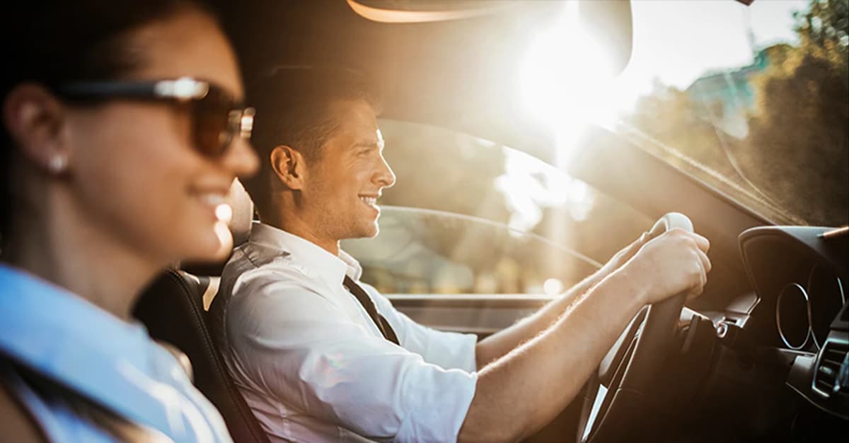 Close-up of two co-workers riding together in a car